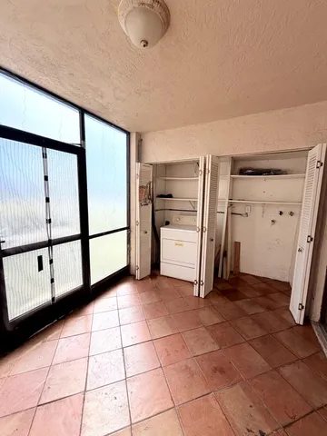 a view of a refrigerator and window in a room