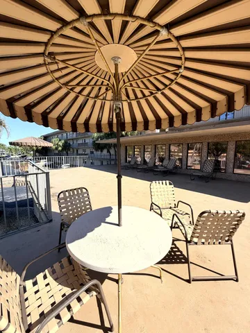 a view of a chairs and table in the patio