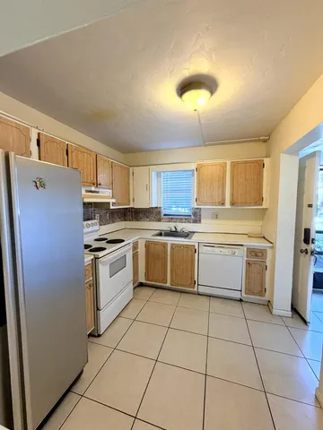 a large kitchen with cabinets and stainless steel appliances
