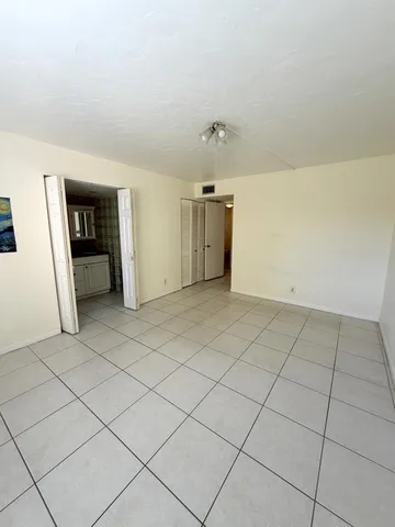 a view of an empty room and closet area