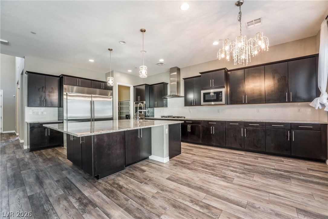 2787 Athens Ridge Drive Henderson, NV 89052 - Photo 6 of 31 An inviting kitchen with a substantial island offers both culinary workspace and social gathering space.