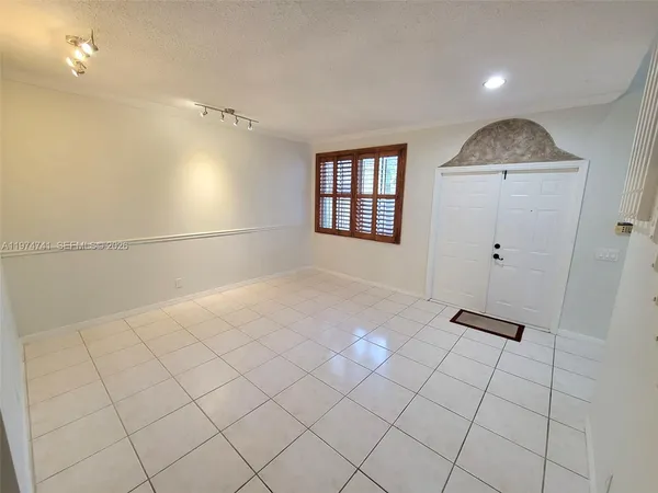 a view of kitchen with cabinets and window