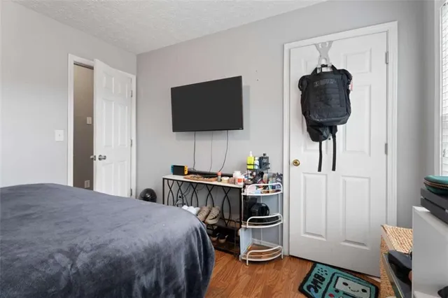 a bedroom with a bed and a flat screen tv