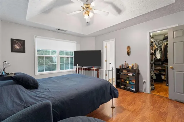 a bedroom with a bed and a flat screen tv