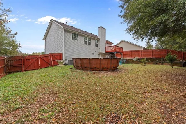 a view of a house with backyard and a tree