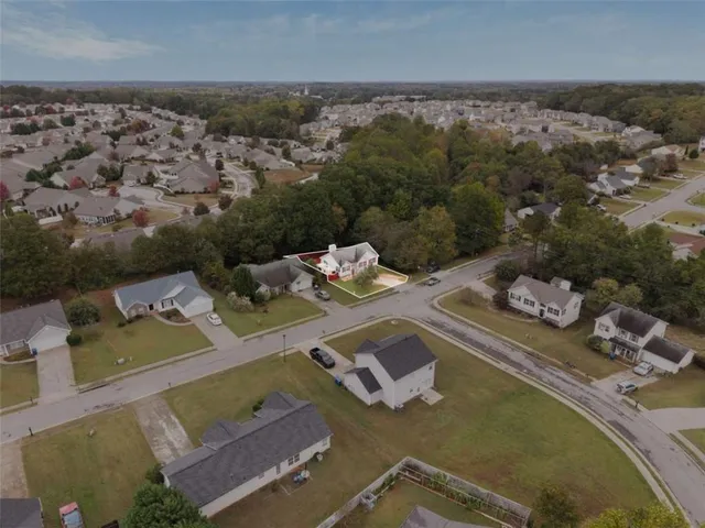 an aerial view of a house with a swimming pool