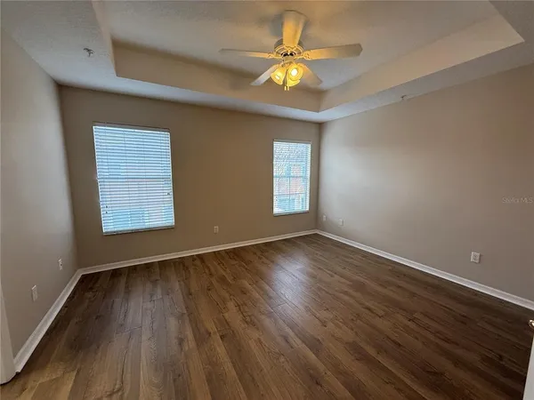 a view of a room with wooden floor