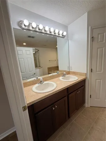 a bathroom with a glass shower door
