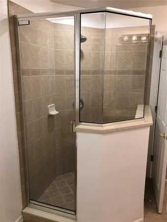 a spacious bathroom with a tub and shower