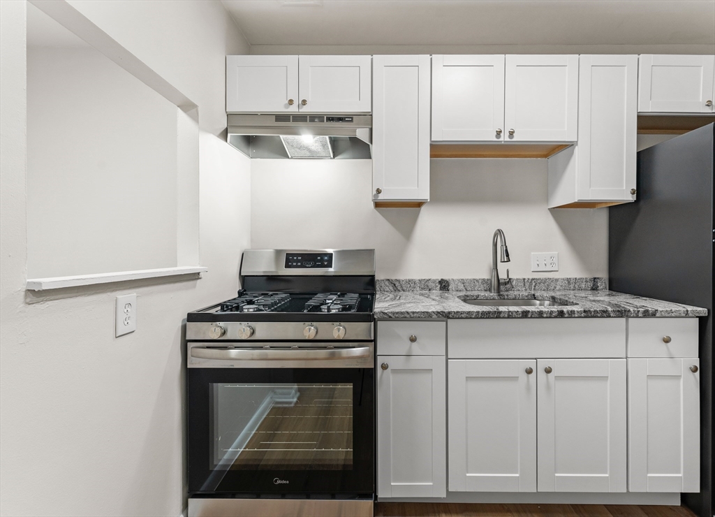 175 Clare Avenue, Unit B3 Boston, MA 02136 - Photo 2 of 22 a kitchen with white cabinets and appliances