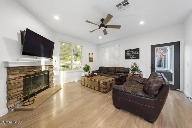 a living room with fireplace furniture and a flat screen tv
