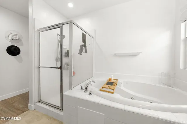 a bathroom with a bathtub and a shower