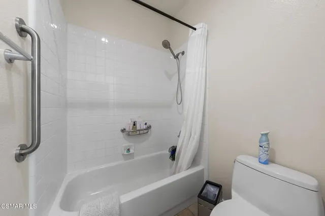 a bath room with a toilet and a bath tub