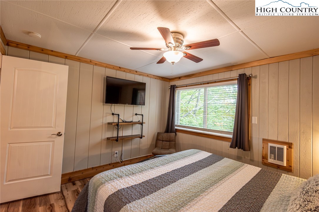 220 Charter Hills Road, Unit A2 Beech Mountain, NC 28604 - Photo 17 of 30 a bedroom with a large bed and a window
