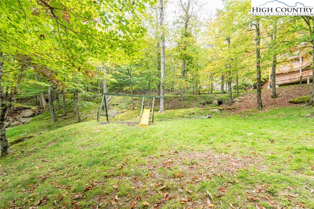 220 Charter Hills Road, Unit A2 Beech Mountain, NC 28604 - Photo 27 of 30 a view of a field with trees in the background
