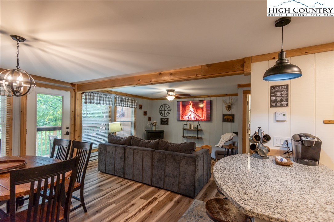 220 Charter Hills Road, Unit A2 Beech Mountain, NC 28604 - Photo 4 of 30 a living room with furniture a flat screen tv and a large window