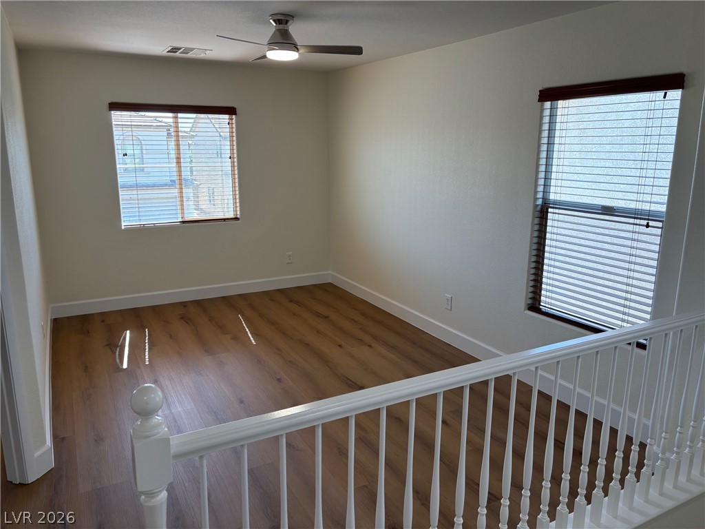4900 Naff Ridge Drive Las Vegas, NV 89131 - Photo 10 of 21 A well-lit landing area with elegant wood flooring offers a comfortable and versatile secondary living space.