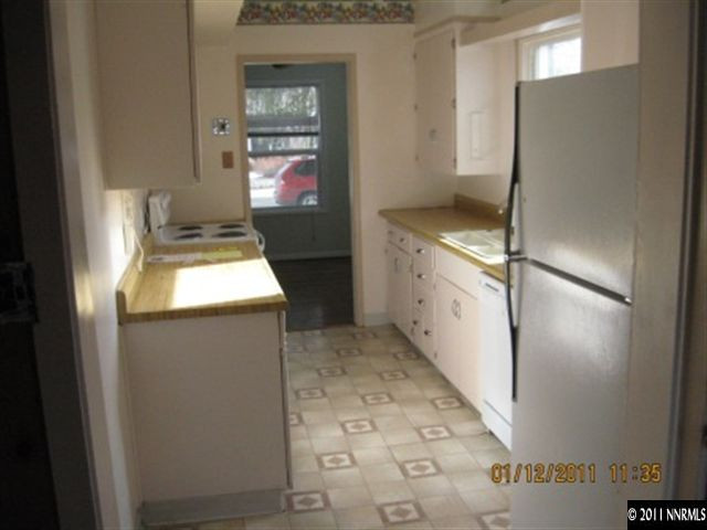 901 Delmar Way Reno, NV 89509 - Photo 3 of 10 a kitchen with white cabinets and white appliances