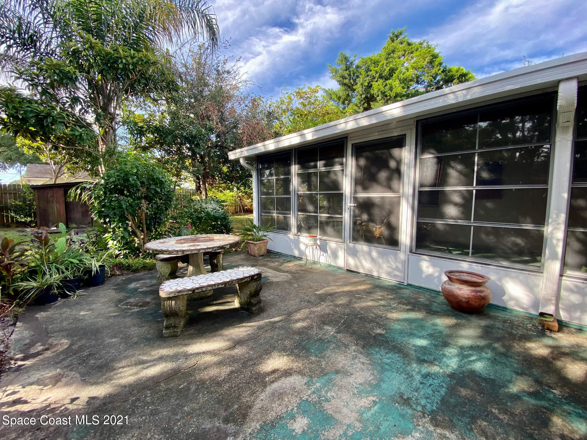 2933 Lancaster Road Melbourne, FL 32935 - Photo 14 of 25 a view of a patio with table and chairs and potted plants