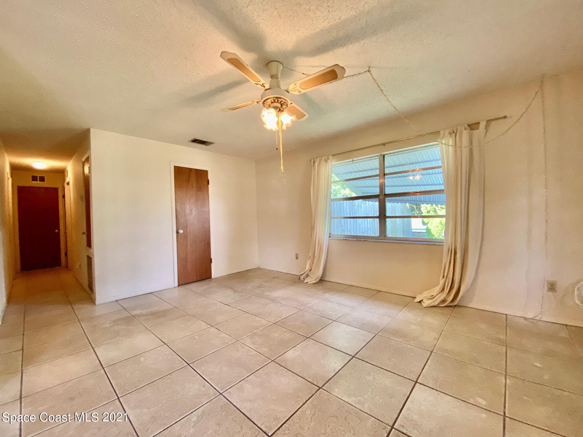 2933 Lancaster Road Melbourne, FL 32935 - Photo 8 of 25 a view of an empty room with a window