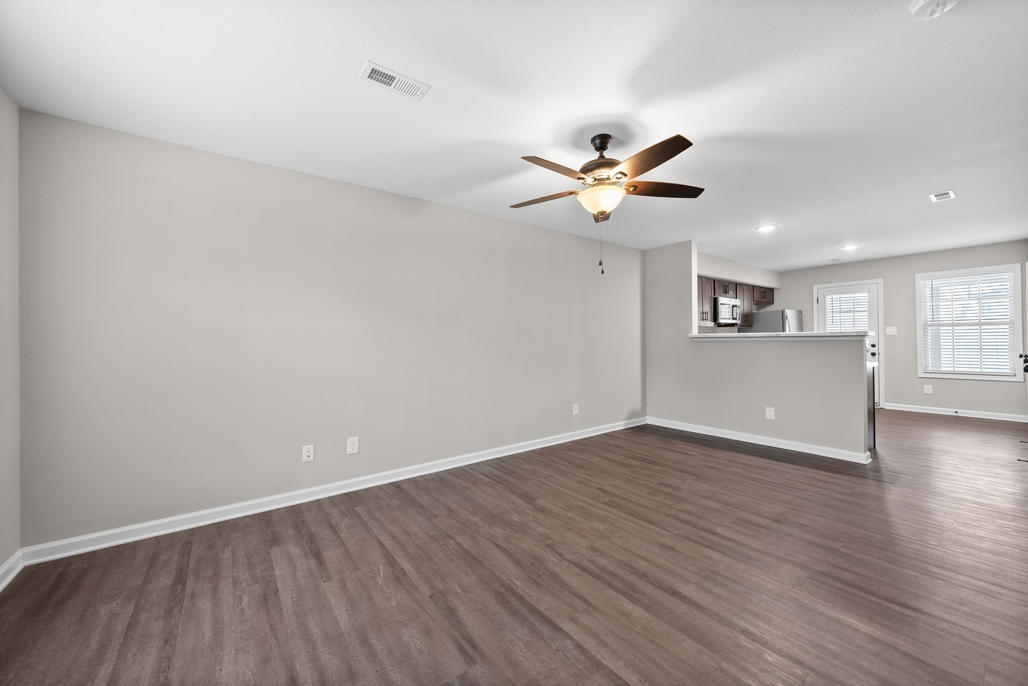 418 Peachers Mill Road, Unit C6 Clarksville, TN 37042 - Photo 3 of 21 a view of a kitchen with wooden floor and a ceiling fan