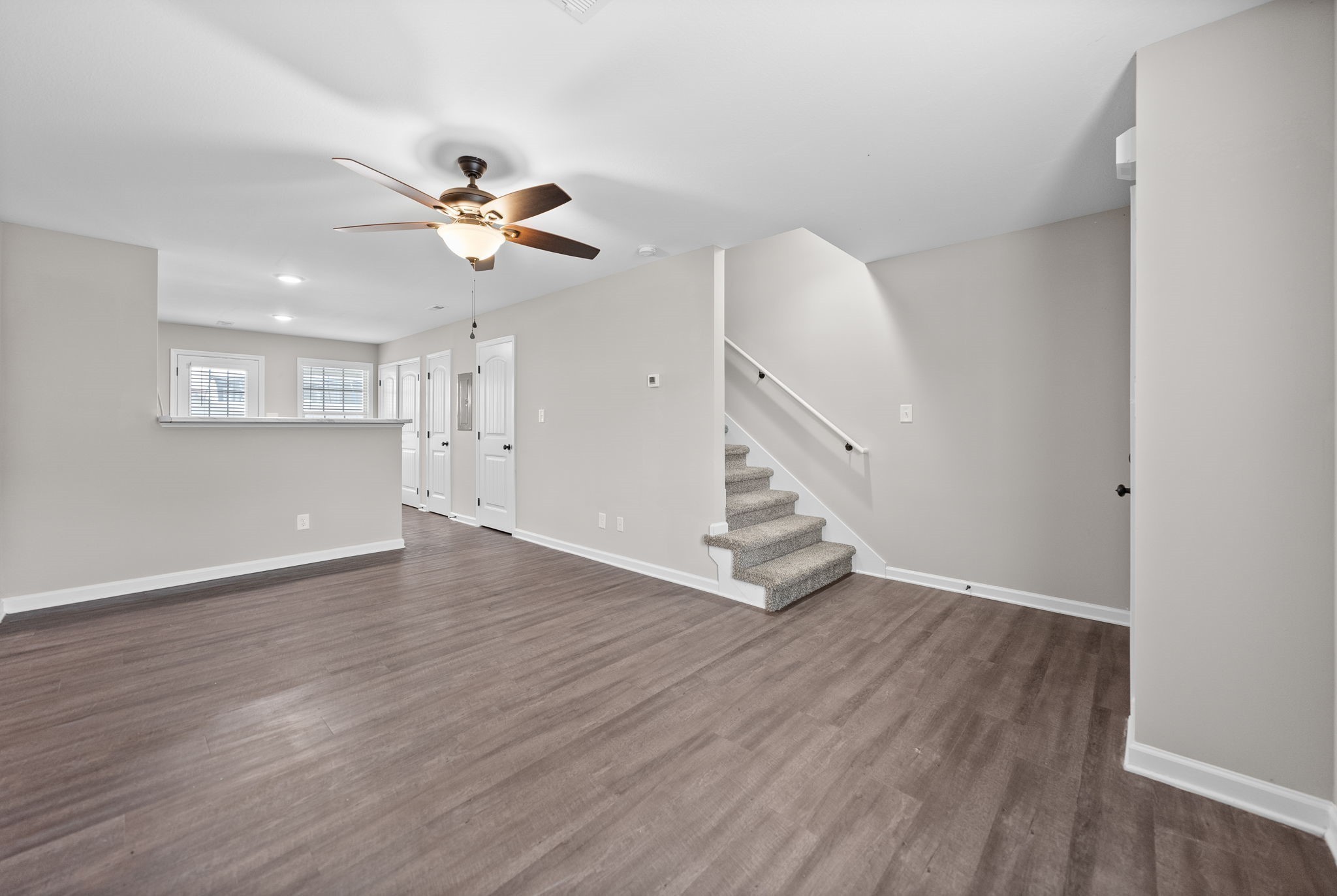 418 Peachers Mill Road, Unit C6 Clarksville, TN 37042 - Photo 4 of 21 a view of an empty room with wooden floor and a ceiling fan