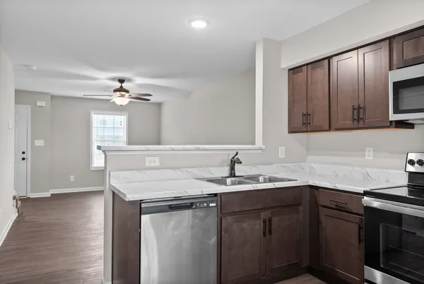 a kitchen with a sink cabinets and wooden floor