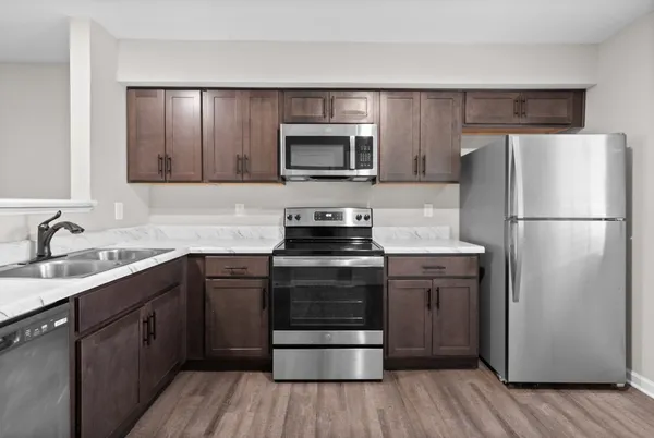 a kitchen with a refrigerator stove and sink