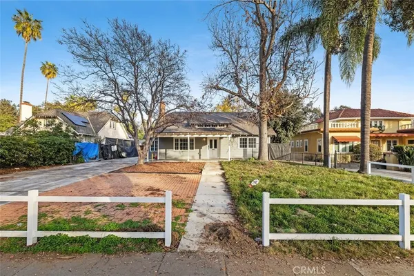 a front view of a house with a garden