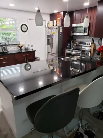 a kitchen with a table and chairs