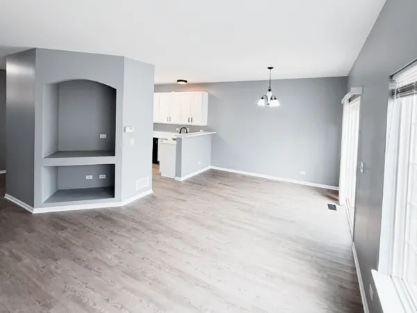 a view of a kitchen with a sink and a refrigerator