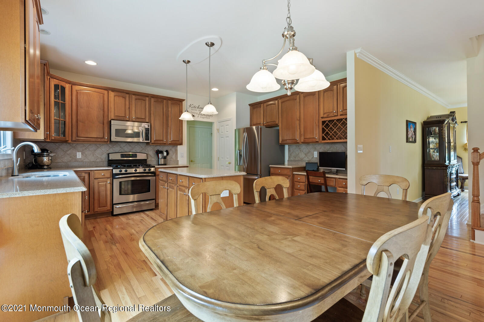 124 Adams Way Jackson, NJ 08527 - Photo 12 of 62 a kitchen with kitchen island a stove a sink a dining table and chairs