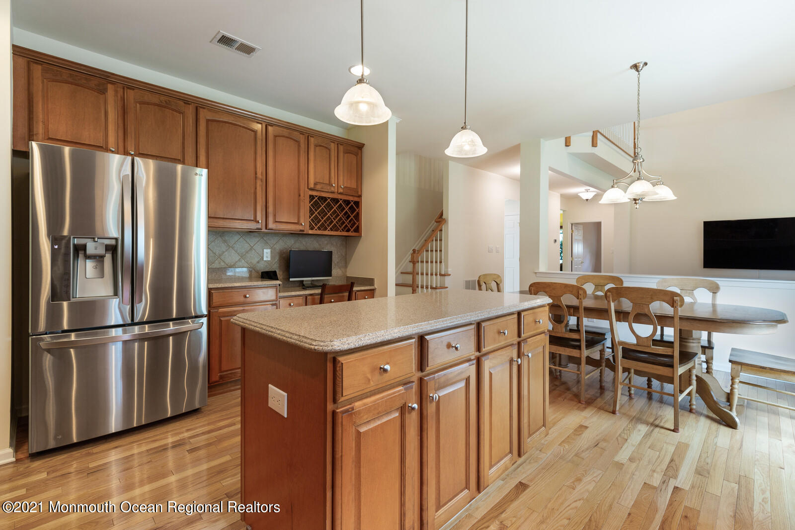 124 Adams Way Jackson, NJ 08527 - Photo 15 of 62 a kitchen with stainless steel appliances granite countertop a refrigerator a sink dishwasher a dining table and chairs with wooden floor