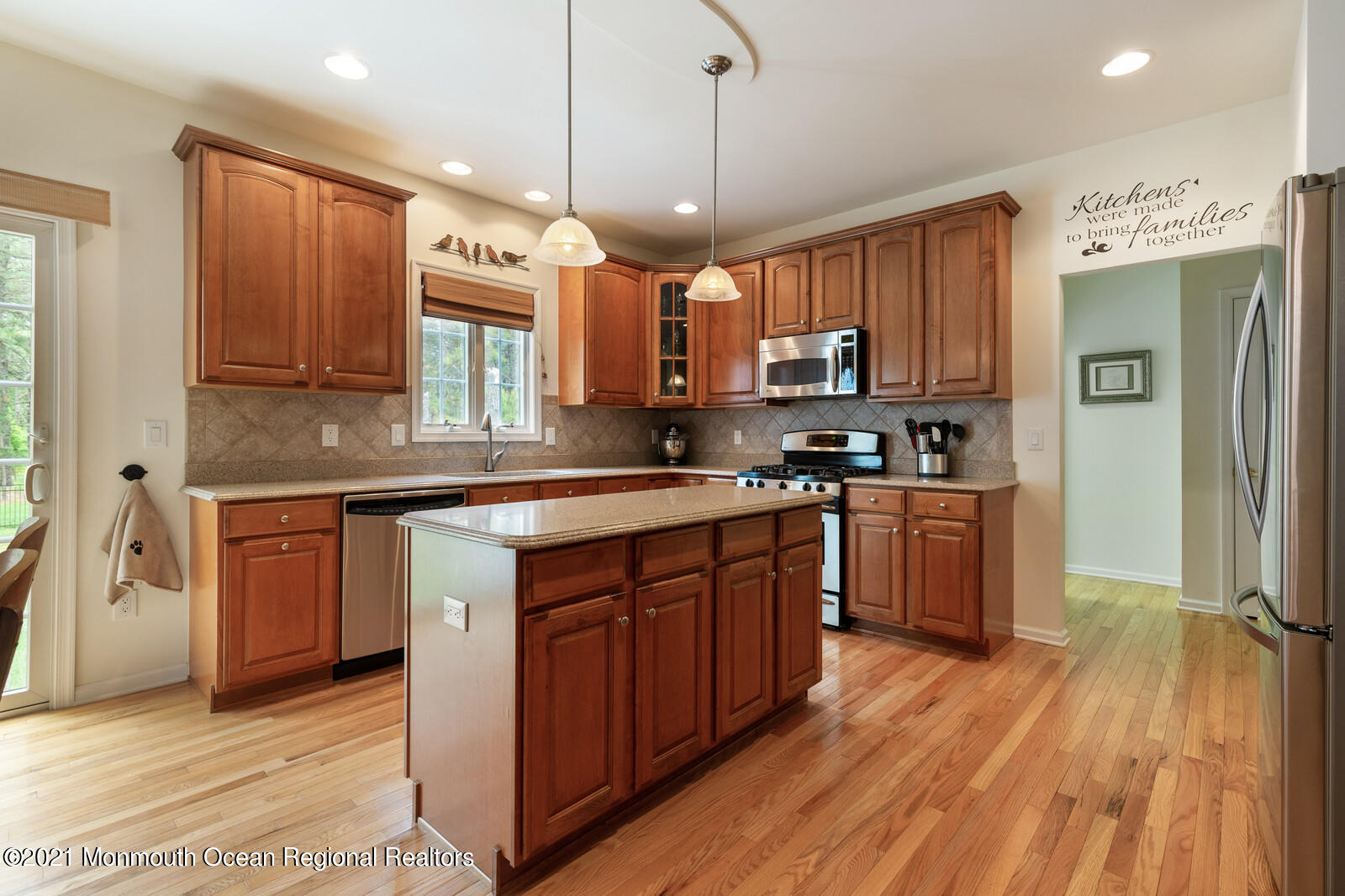 124 Adams Way Jackson, NJ 08527 - Photo 18 of 62 a kitchen with kitchen island granite countertop wooden floors stainless steel appliances a sink and a window