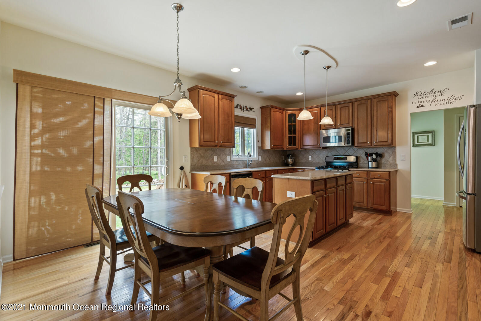 124 Adams Way Jackson, NJ 08527 - Photo 21 of 62 a kitchen with stainless steel appliances granite countertop a stove a refrigerator a oven a sink with a dining table and chairs