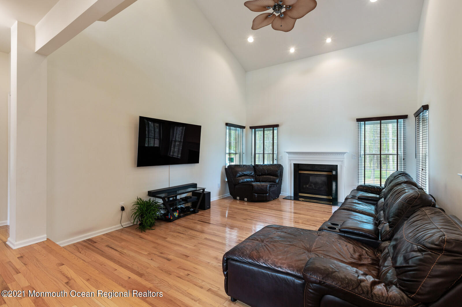 124 Adams Way Jackson, NJ 08527 - Photo 24 of 62 a living room with furniture a fireplace and a flat screen tv