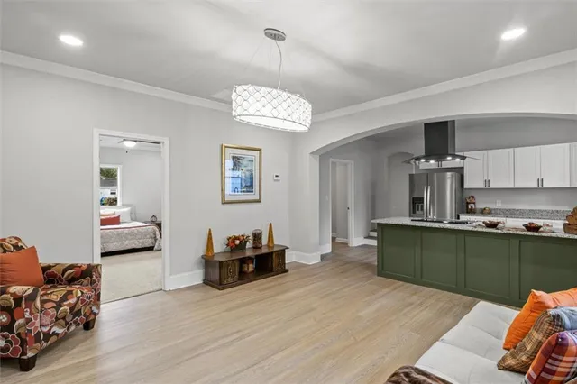 a living room with furniture and a wooden floor