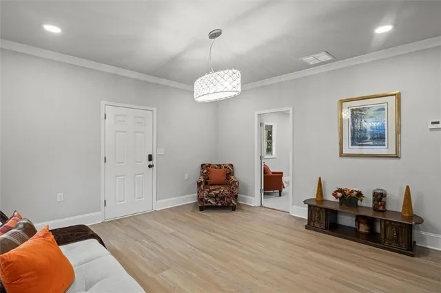 a bedroom with furniture and wooden floor
