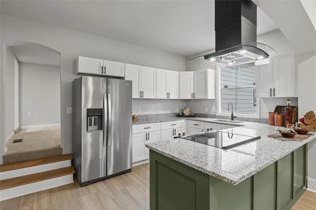 a kitchen with stainless steel appliances granite countertop a sink stove and refrigerator