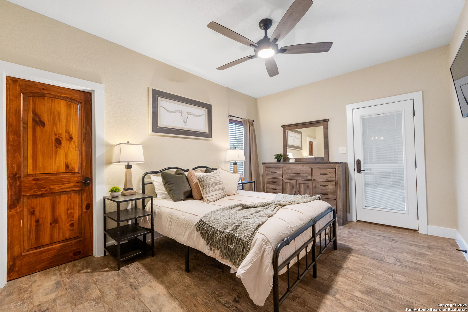 115 Spanish Pass Road Boerne, TX 78006 - Photo 22 of 50 a bedroom with a bed a ceiling fan and a dresser