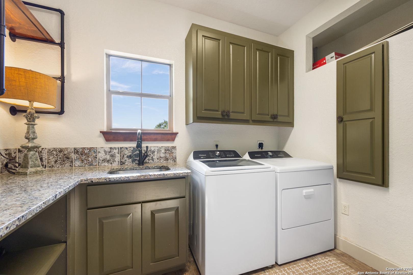 115 Spanish Pass Road Boerne, TX 78006 - Photo 29 of 50 a kitchen with a sink and a refrigerator