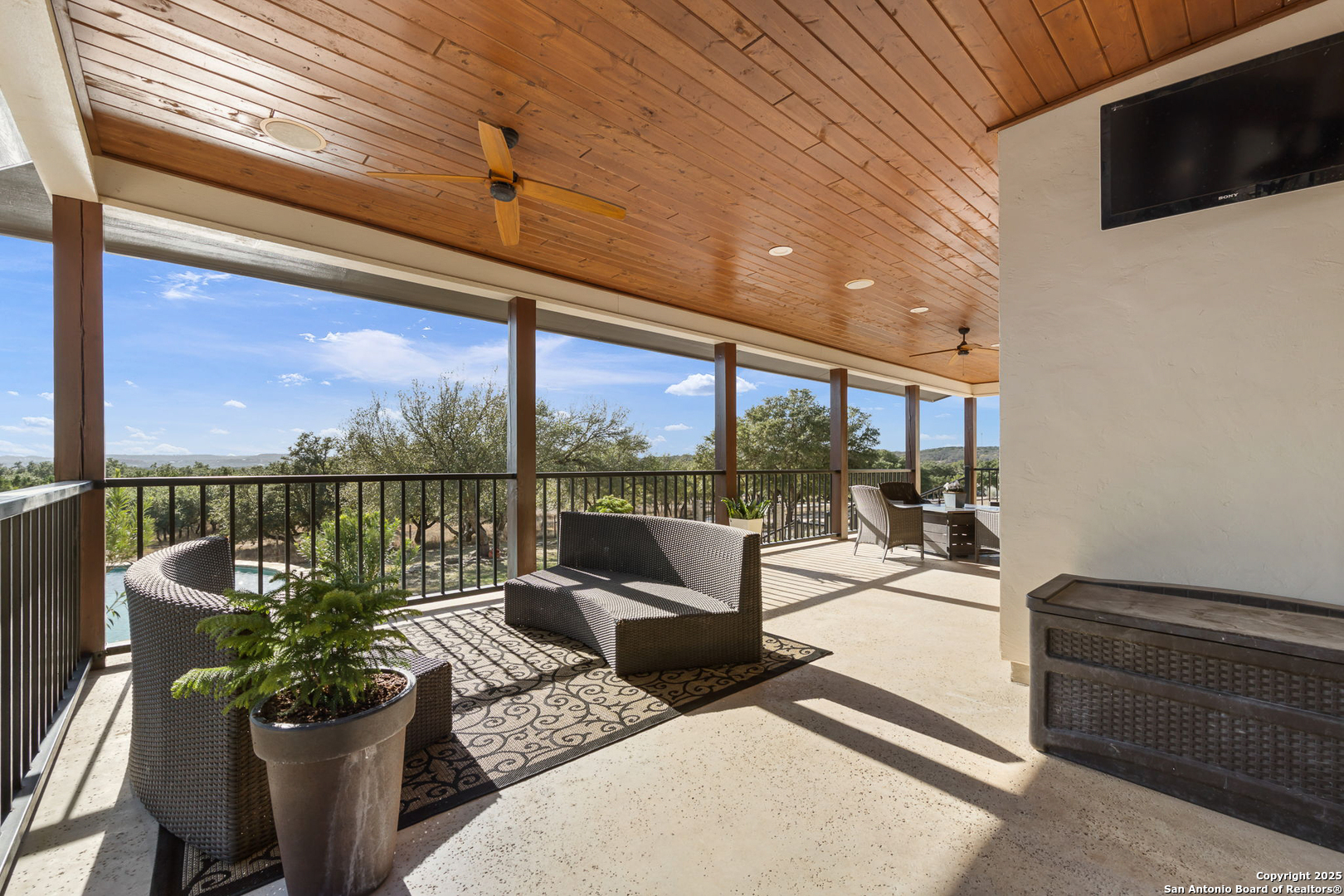 115 Spanish Pass Road Boerne, TX 78006 - Photo 34 of 50 a living room with couches a coffee table and chairs with the view of balcony