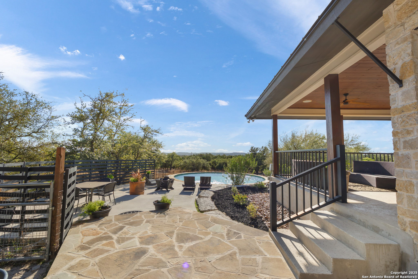 115 Spanish Pass Road Boerne, TX 78006 - Photo 35 of 50 a view of a balcony with dining table and chairs with wooden floor and fence