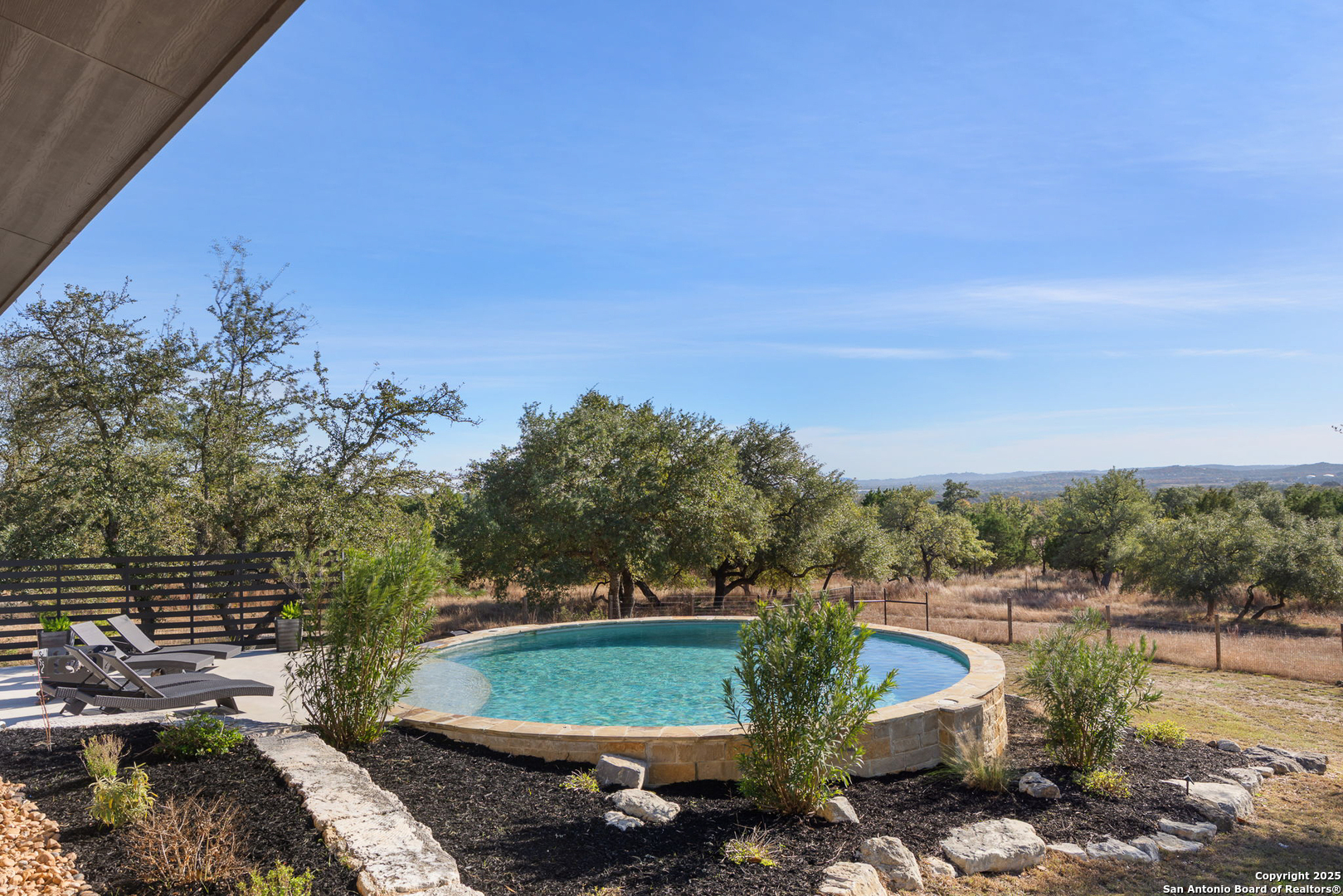 115 Spanish Pass Road Boerne, TX 78006 - Photo 37 of 50 a view of a backyard with plants and trees