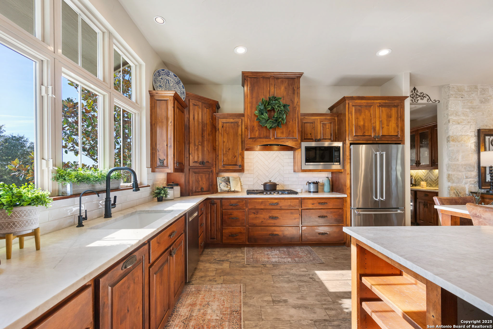 115 Spanish Pass Road Boerne, TX 78006 - Photo 7 of 50 a large kitchen with stainless steel appliances granite countertop a lot of counter space and a sink