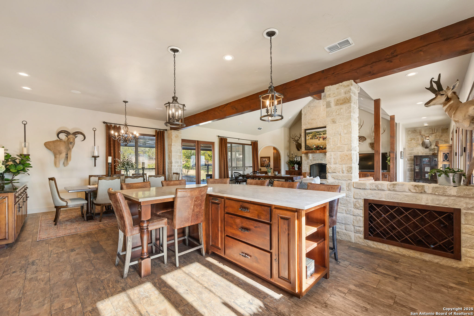 115 Spanish Pass Road Boerne, TX 78006 - Photo 9 of 50 a open kitchen with stainless steel appliances granite countertop a stove and chairs