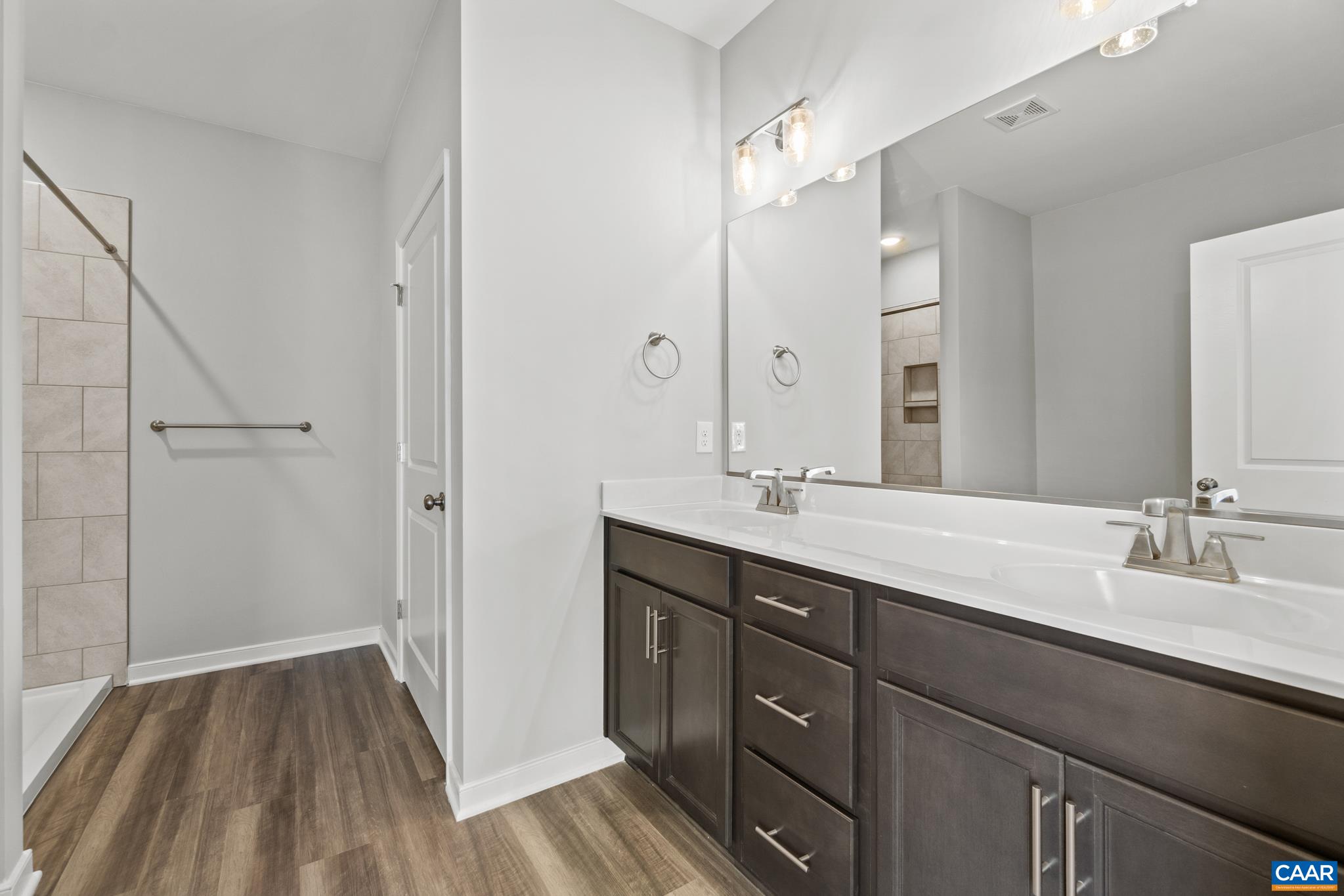 Lot 4 Hells Bend Road Palmyra, VA 22963 - Photo 13 of 21 a bathroom with a double vanity sink and mirror