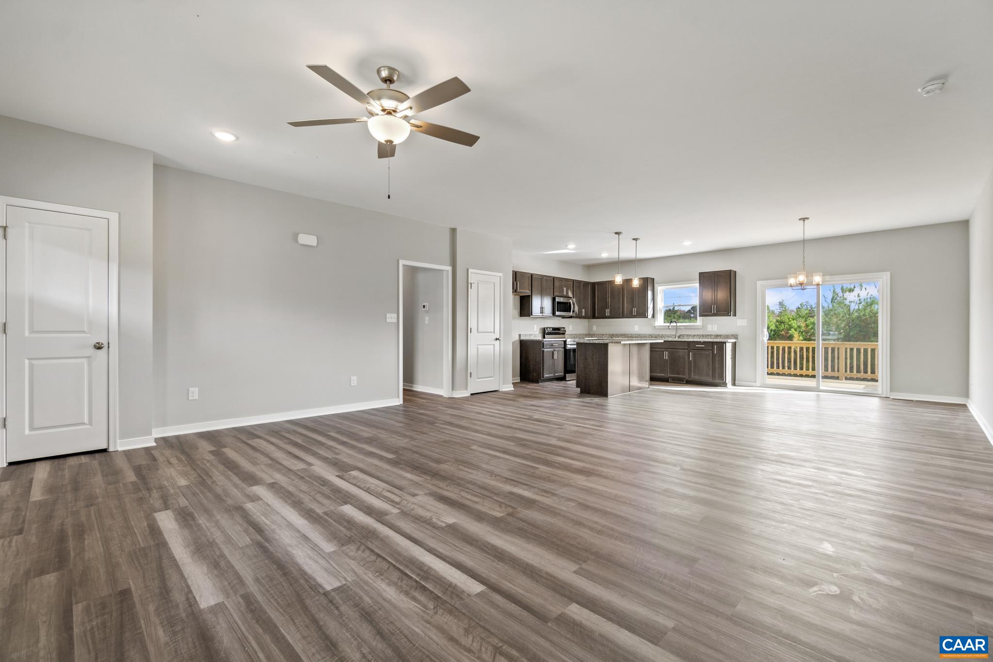 Lot 4 Hells Bend Road Palmyra, VA 22963 - Photo 4 of 21 a view of a livingroom with wooden floor and a ceiling fan