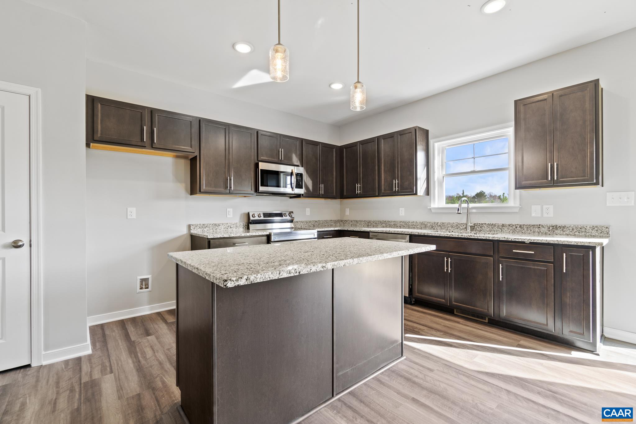 Lot 4 Hells Bend Road Palmyra, VA 22963 - Photo 6 of 21 a kitchen with kitchen island granite countertop a sink cabinets and stainless steel appliances