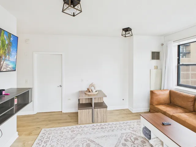 a living room with furniture and a rug
